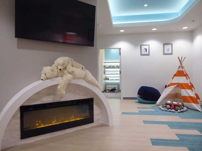inside the office with stuffed polar bears, fake fireplace, beanbag, tepee, fake fire pit and TV