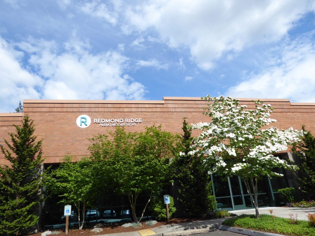 Redmond Ridge Pediatric Dentistry office from the outside with trees